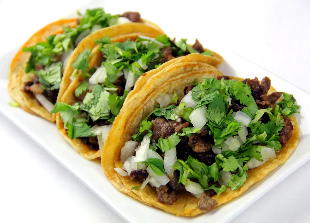 Carne asada street tacos with chopped grilled steak, onions and cilantro