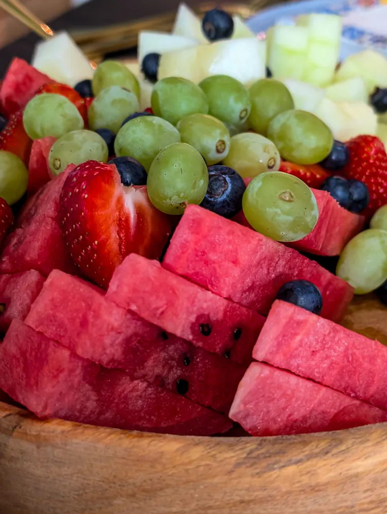 Fresh fruit bowl with strawberries, watermelon, grapes, melon and blueberries