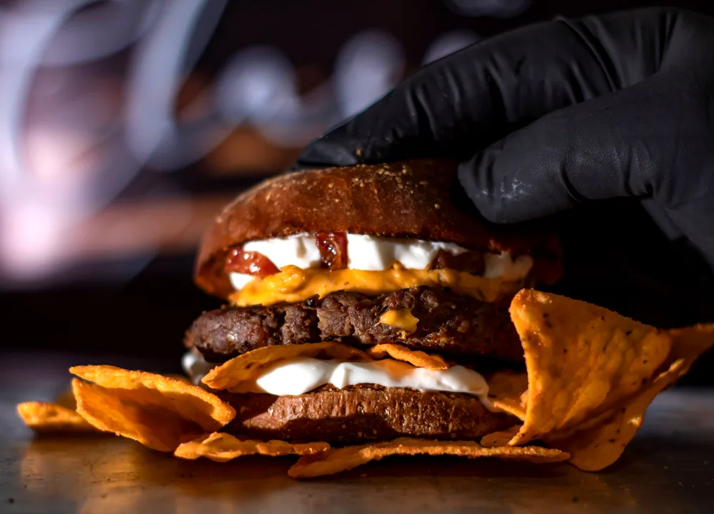 Double-patty smash burger upgrade with melted cheese, onions and house sauce on a brioche bun